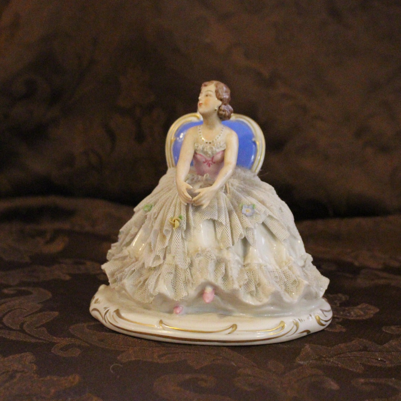 Franz Wittwer Glassworks lady sitting figurine in blue and pink with various color flowers.  Fine lace on dress